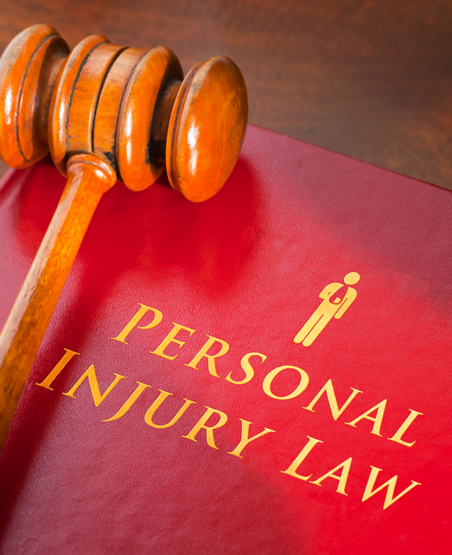A judge's gavel rests on a red book titled 'Personal Injury Law.'